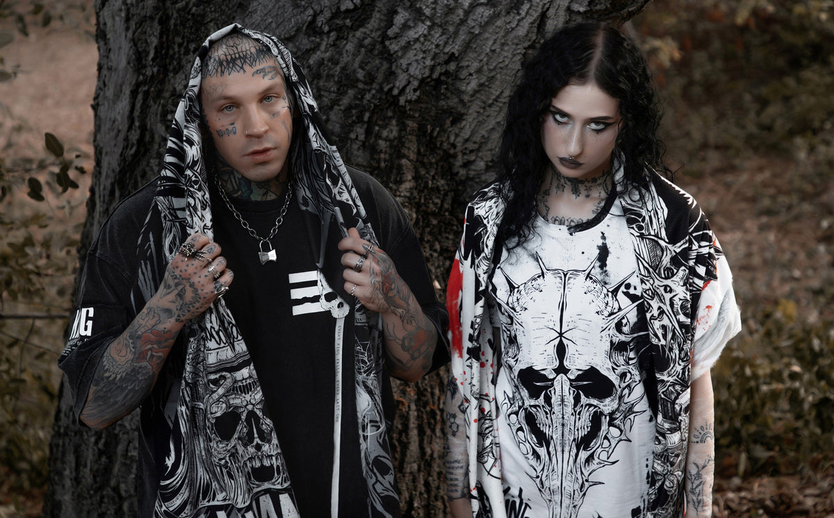Two models wearing oversized black and white Scummy Bears artist collaboration shirts outdoors