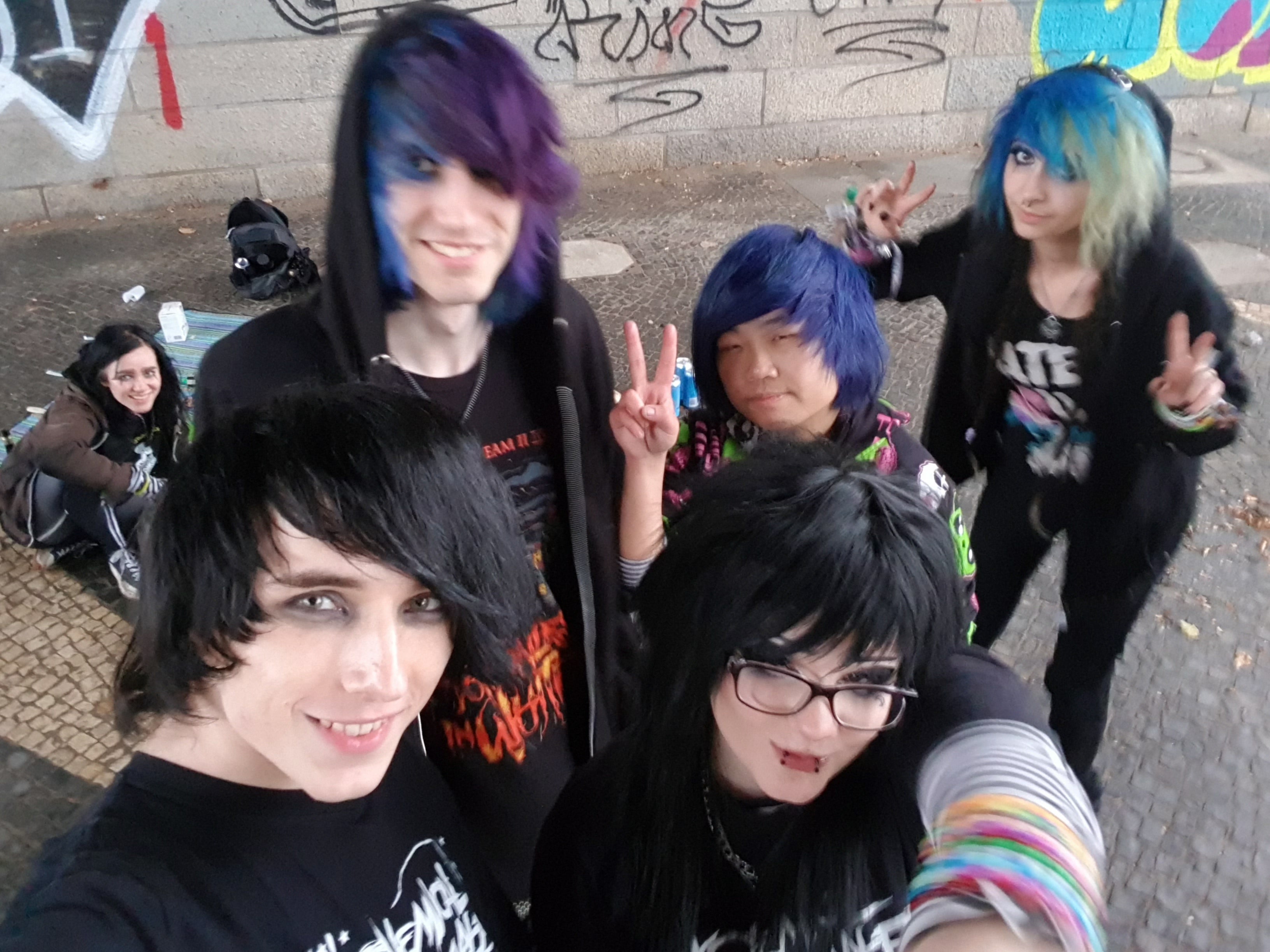 Group of emo and scene people with colorful hair and dark alternative clothing at an emo meetup in Düsseldorf in 2022